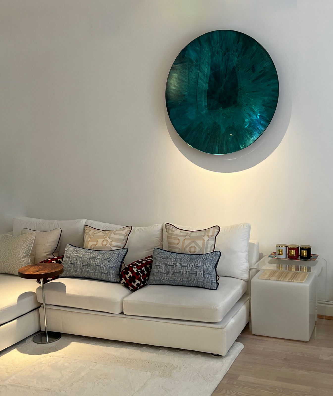 The living room of a client’s London apartment, featuring a  handmade mirrored statement piece specially sourced and hand-transported from France