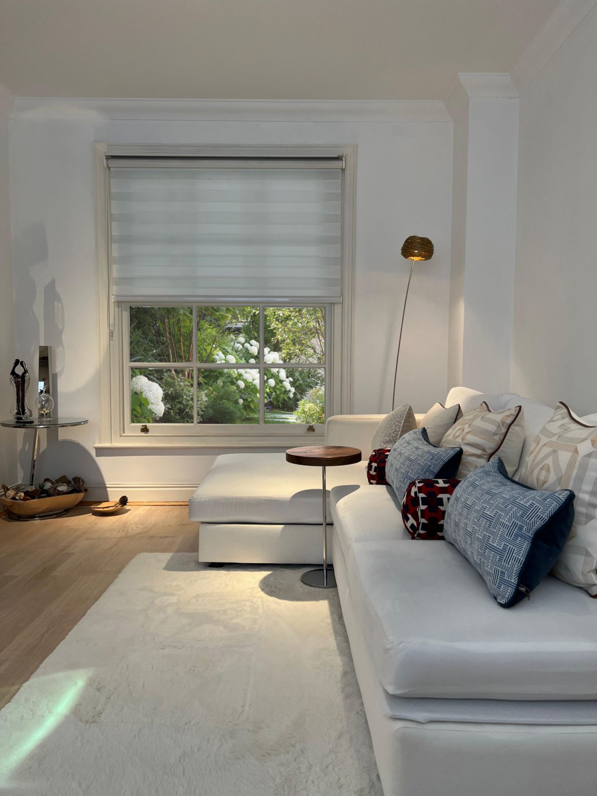 The living room of a London apartment with garden views