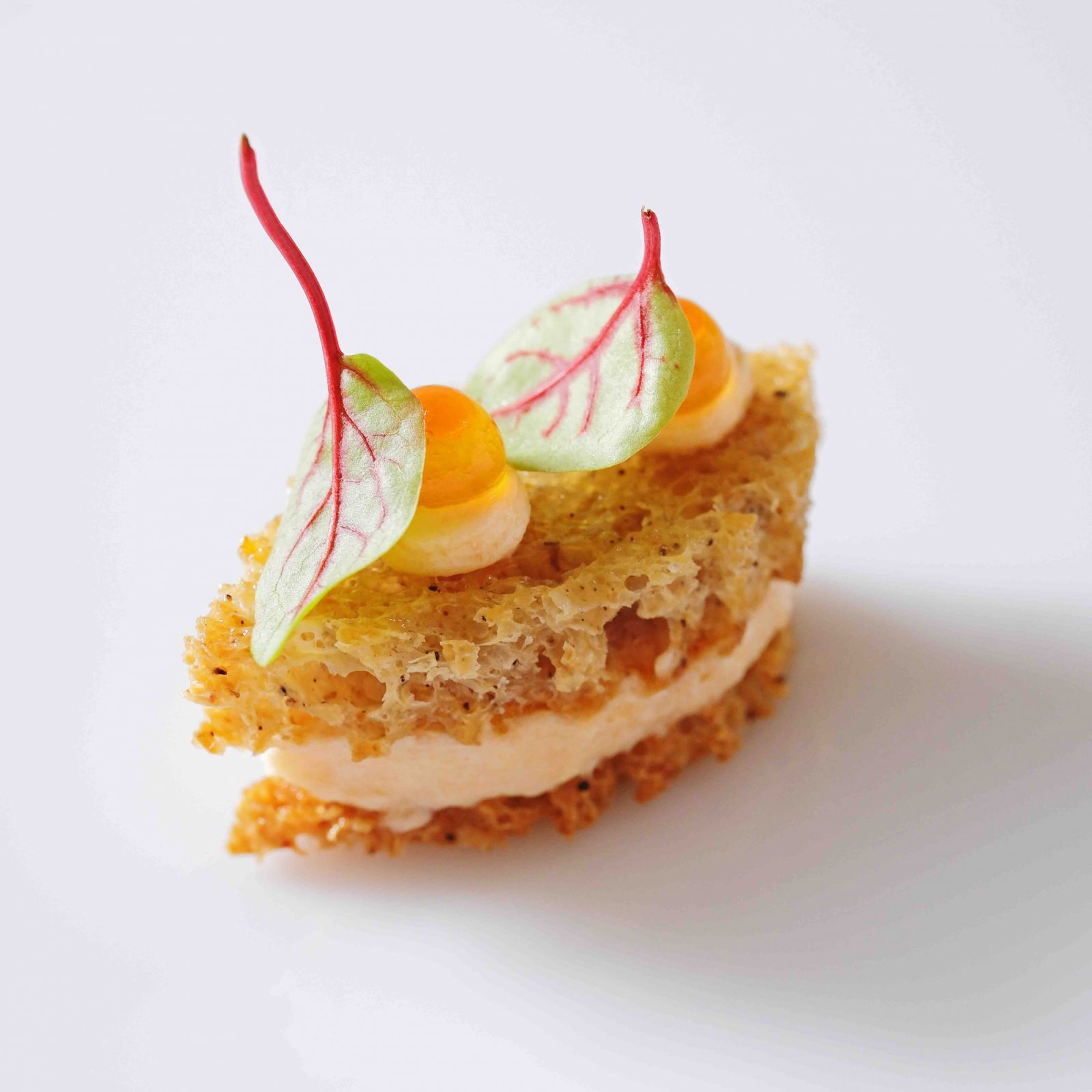 Crisp sourdough leaf mini smoked trout sandwich with Hokkaido trout ikura and red vein sorrel