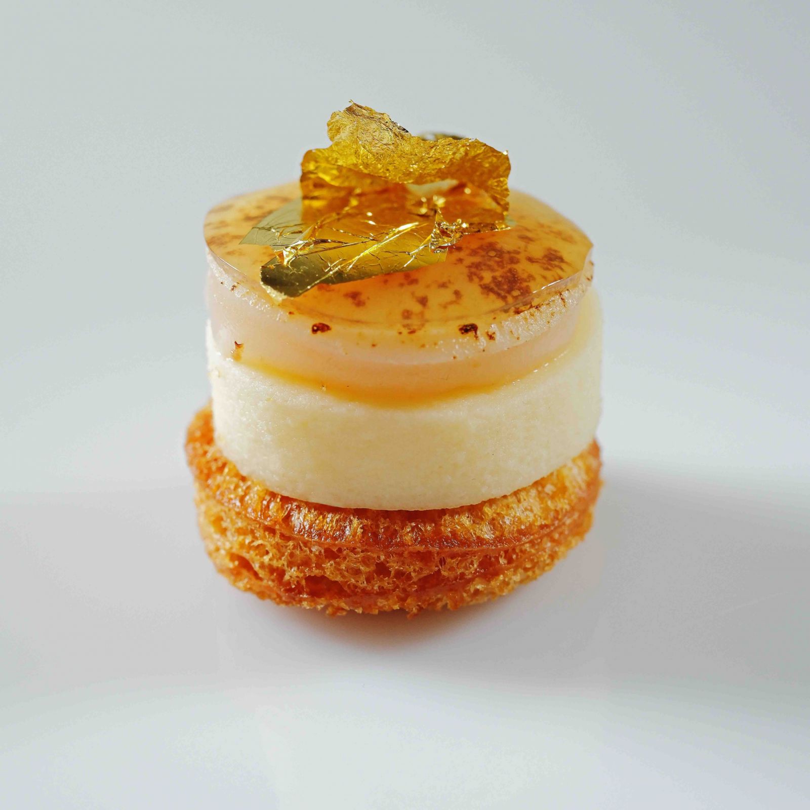 Hokkaido scallop aburi on brioche toast with dashi jelly katsuobushi and gold leaf