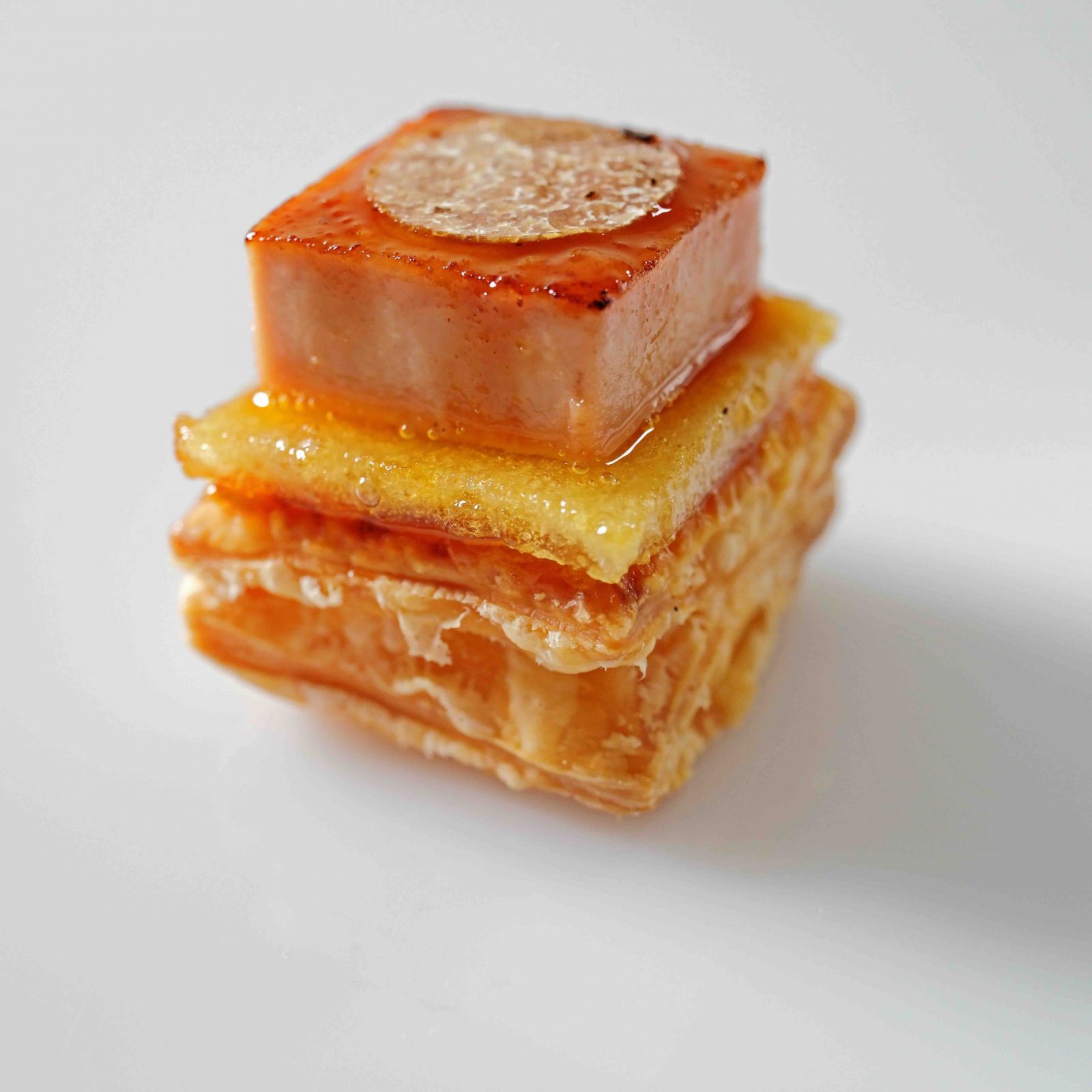 Foie gras brûlée version 2024 with green apple gel, caramelised green apple, puff pastry and summer truffle