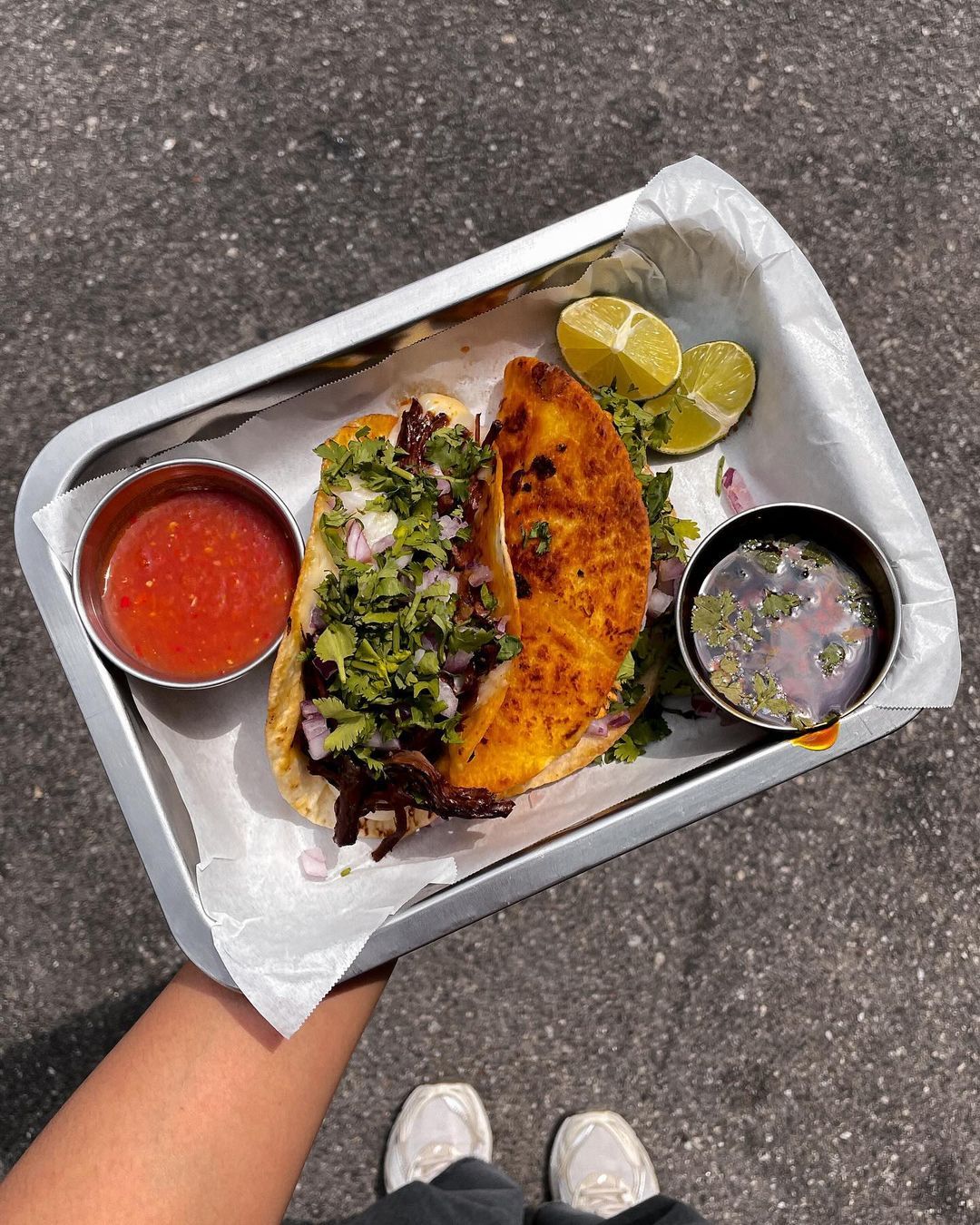 Birria tacos served with a side of consommé (Photo: Instagram / @comienzomy)