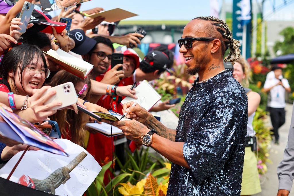 SINGAPORE, SINGAPORE - SEPTEMBER 17: Lewis Hamilton of Great Britain and Mercedes AMG interacts with fans outside the paddock during the F1 Grand Prix of Singapore at Marina Bay Street Circuit on September 17, 2023 in Singapore, Singapore. (Photo by Kym Illman/Getty Images)