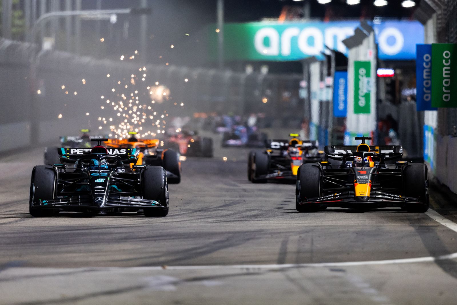 SINGAPORE, SINGAPORE - SEPTEMBER 17: George Russell of Great Britain driving the (63) Mercedes AMG Petronas F1 Team W14 and Max Verstappen of the Netherlands driving the (1) Oracle Red Bull Racing RB19 compete for position on track during the F1 Grand Prix of Singapore at Marina Bay Street Circuit on September 17, 2023 in Singapore, Singapore. (Photo by Clive Rose/Getty Images)