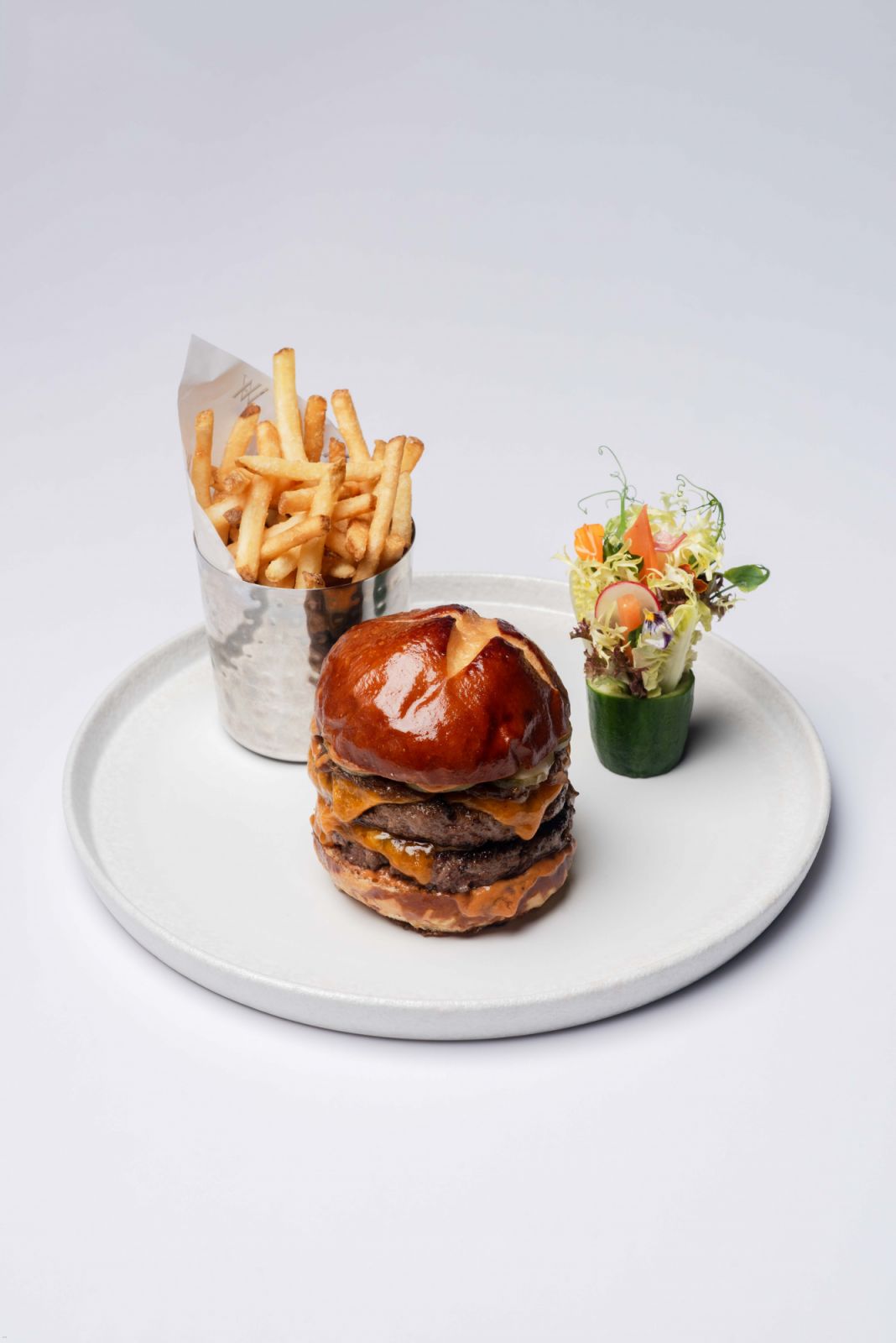 Burger and fries and Waldorf Astoria Maldives