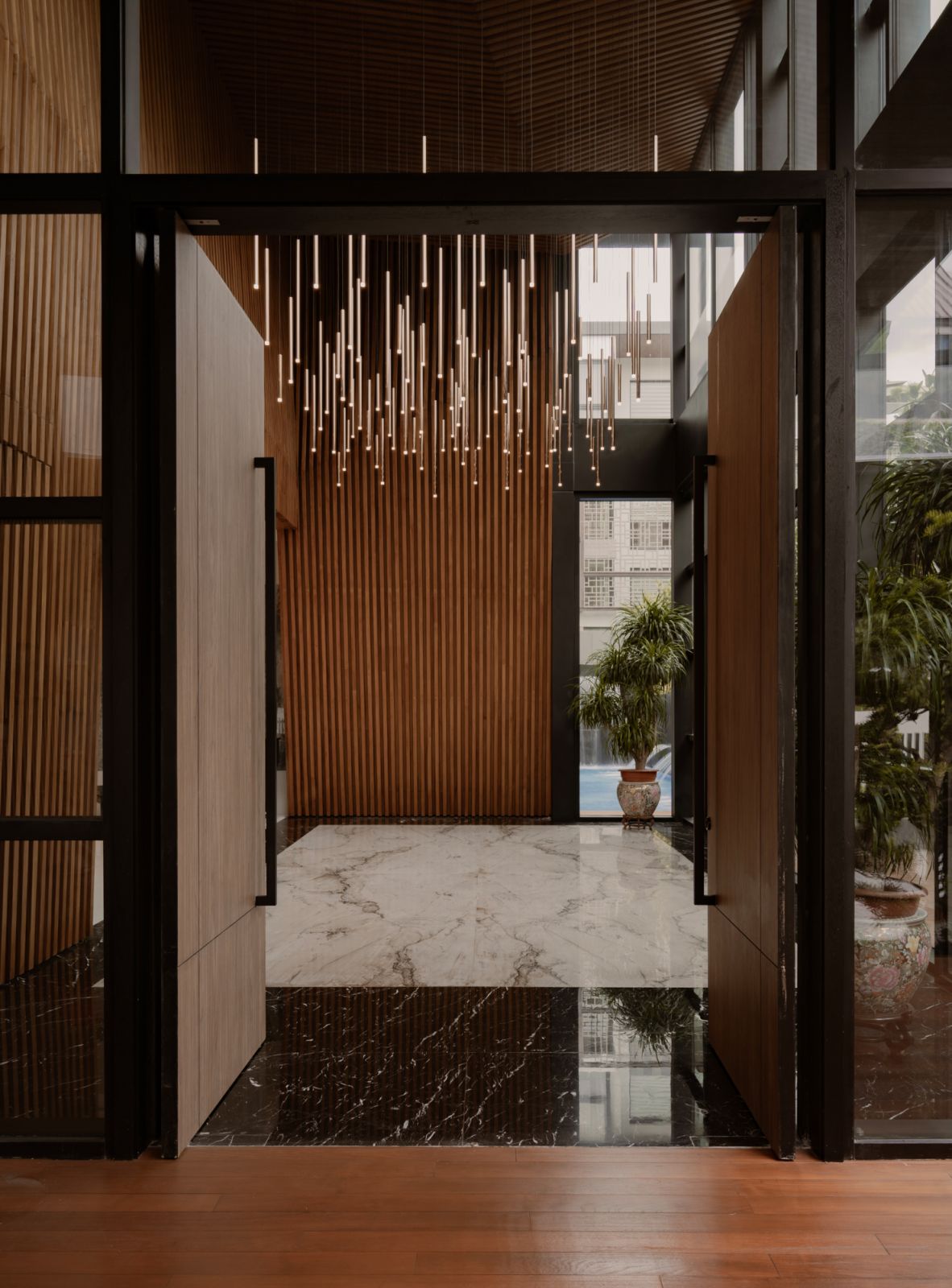 The Holland Grove house entrance greets guests with an artistic light installation on the ceiling