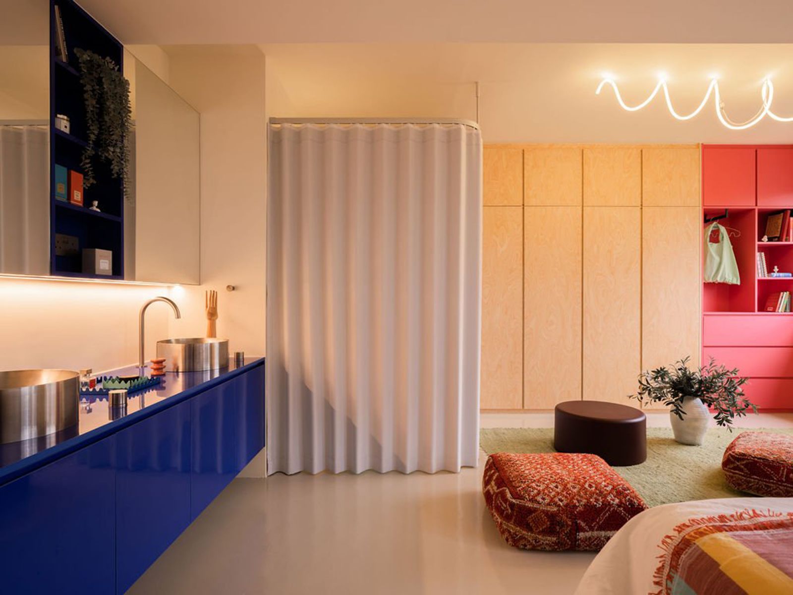 The Coesa ripple fold blackout curtains on a custom suspended track system in a residential space by Knock Knock Studio