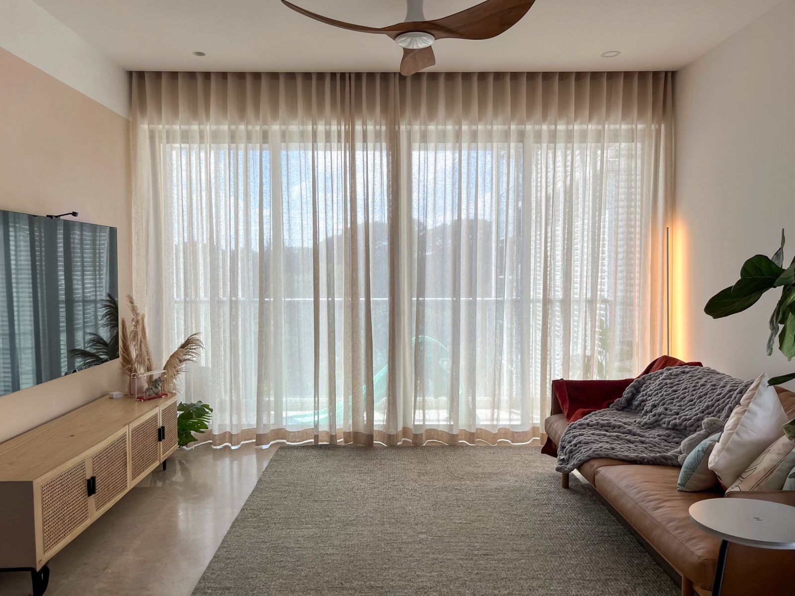 A sustainable linen and cotton mix was used to craft the Coesa ripple fold curtains in this living area