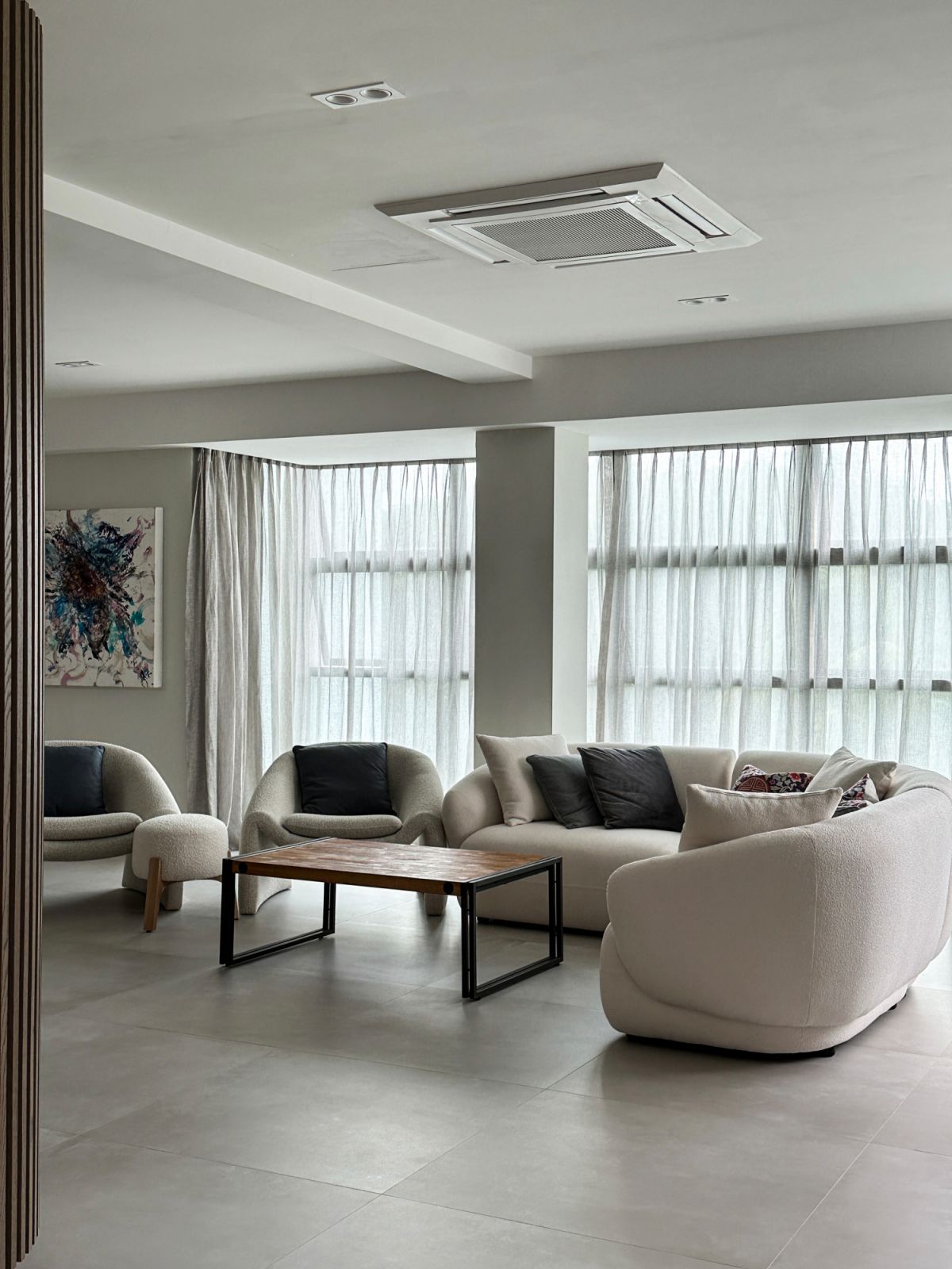 A set of sustainably crafted double-pleated linen curtains in a Singapore living room