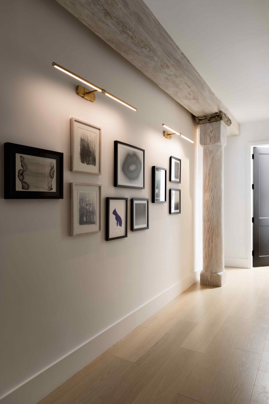 A collection of the homeowners’ existing artworks line the wall