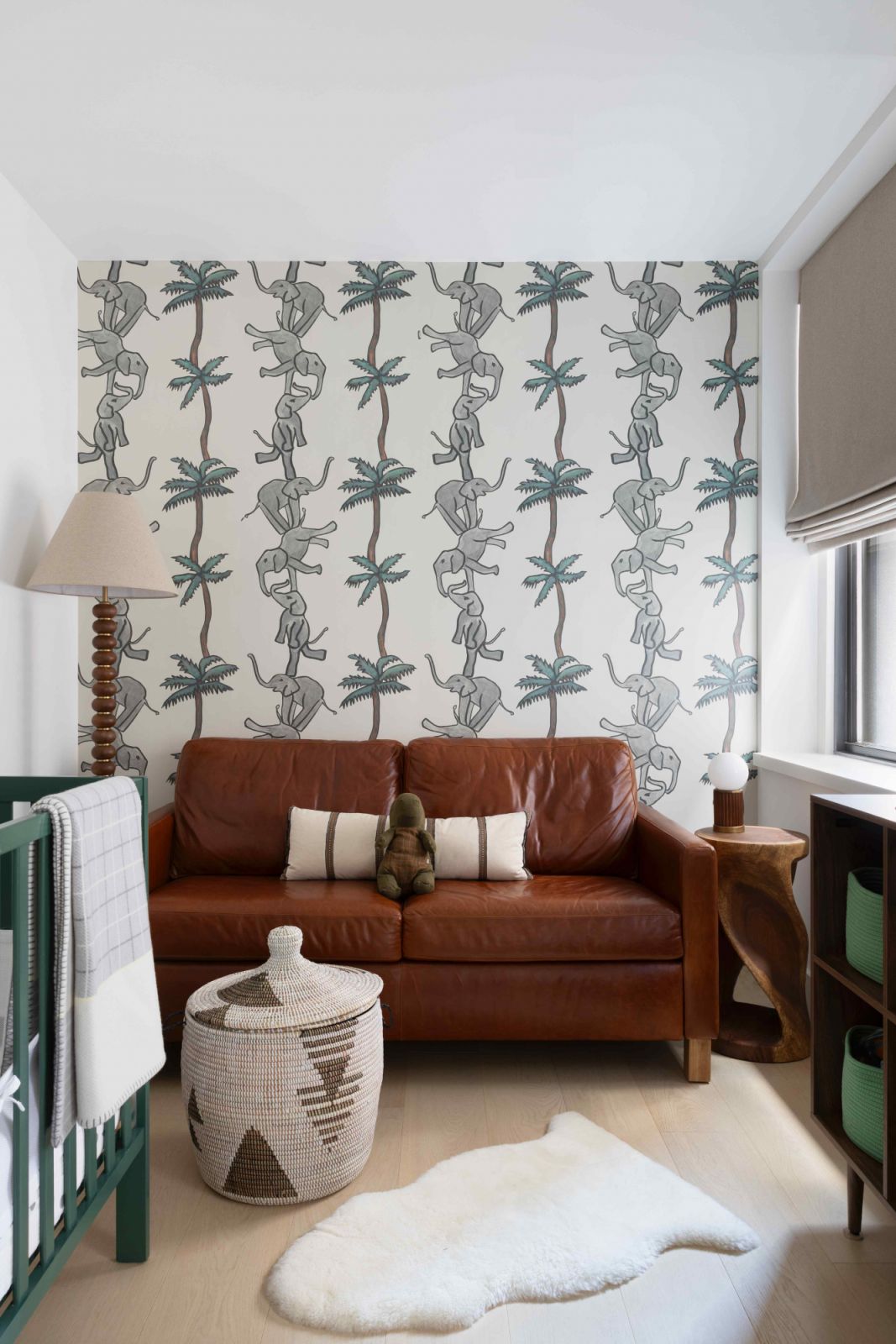 The son's safari-themed nursery with a leather sofa bed