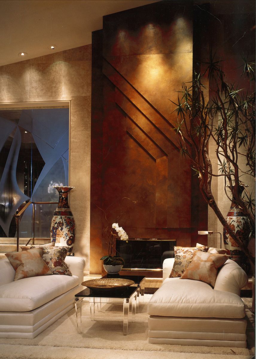 A stately living room with a copper feature wall in a Beverly Hills mansion by Isabelle Miaja