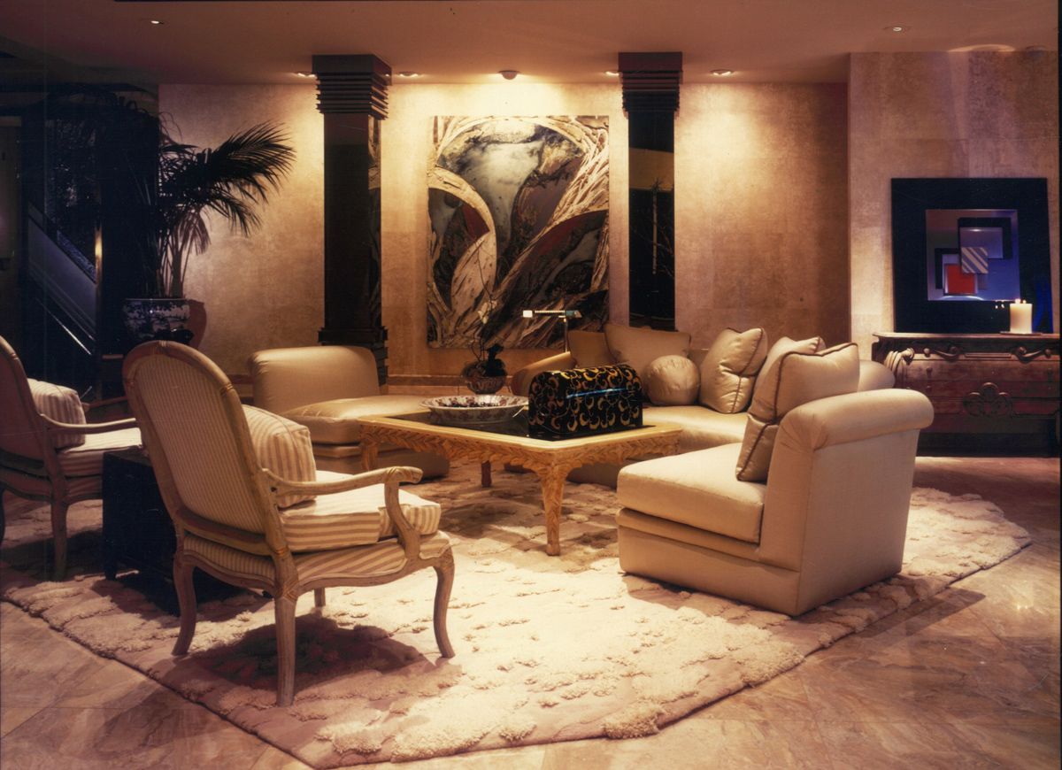 A dramatically lit painting anchors the Beverly Hills mansion’s living room interior