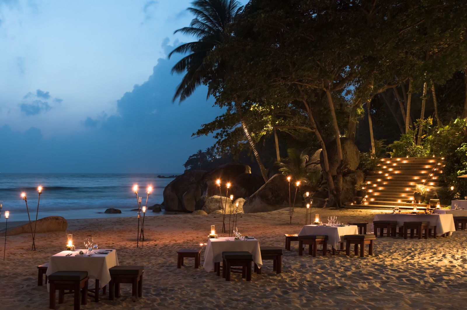 Romantic barbecue dinner on the beach at sunset at Amanpuri