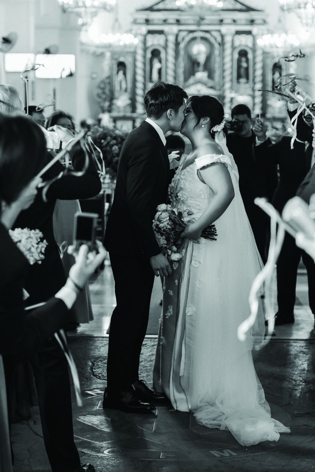 Sharing a kiss at Santuario de San Antonio Parish