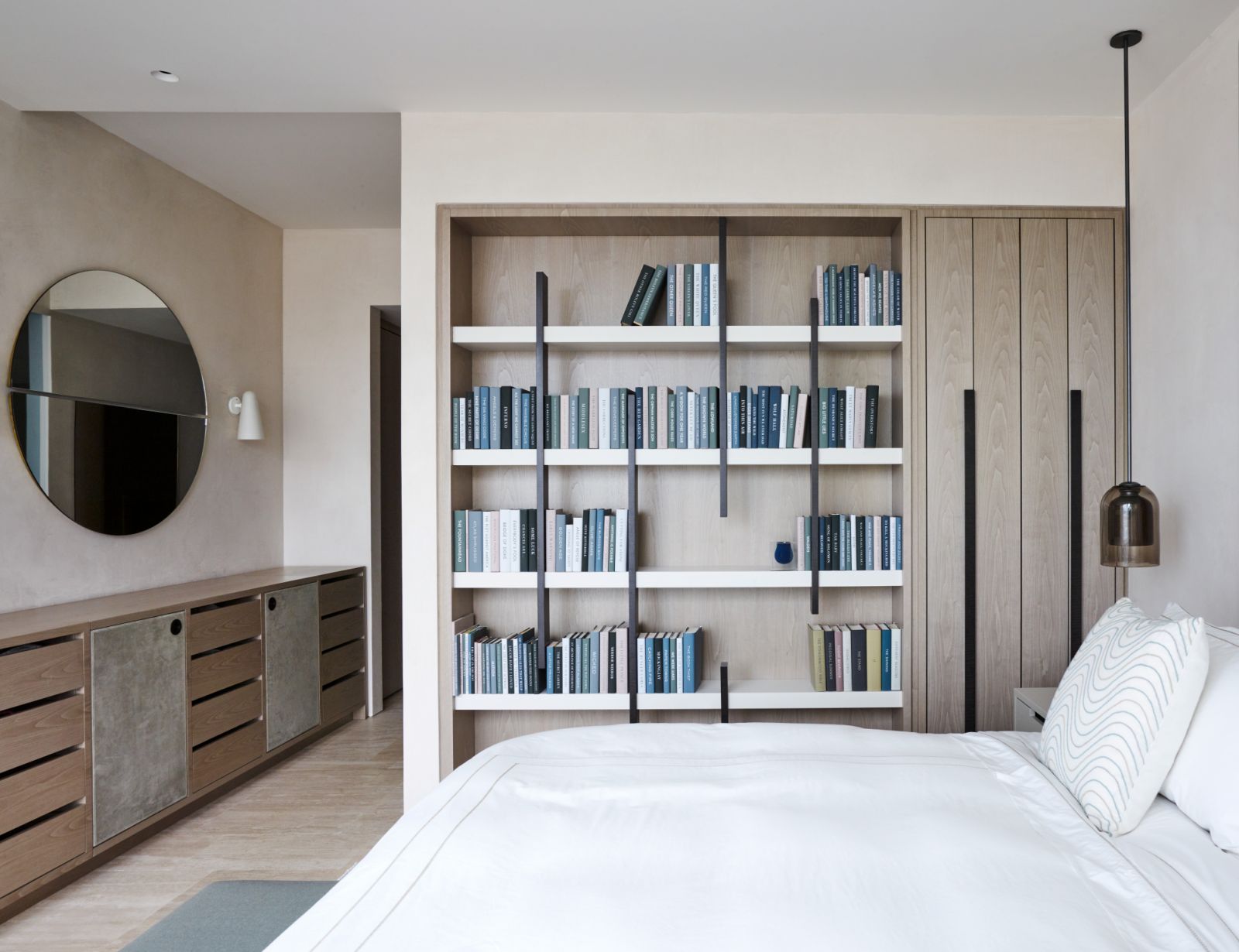 London-based Thorp Design transforms the bedroom into a dual-function space with a bookcase serving as a room divider (Photo: Thorp Design)