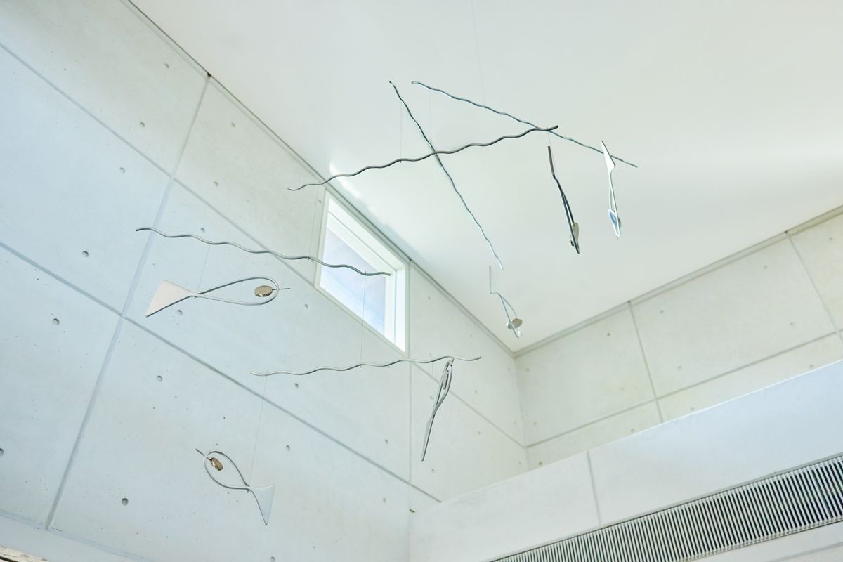 The fish mobile sculpture by Sun Yu-Li lends a playfulness to Ernesto Bedmar’s brutalist architecture