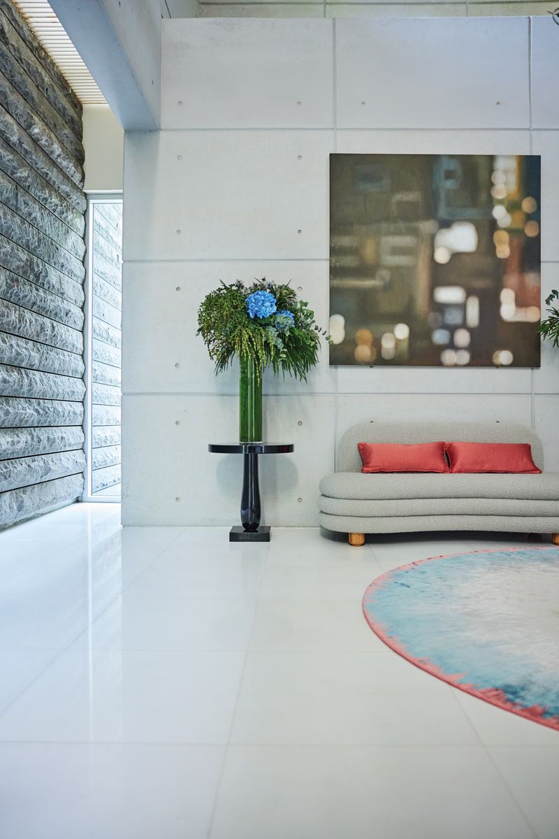 A painting of an urbanscape seemingly viewed through a window blurred by the rain gives the foyer a romantic air