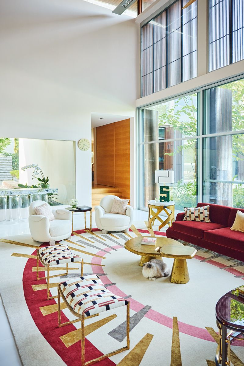 The homeowners share their homes with four cats, one of which is the ragdoll that accompanied our shoot, seen here lounging beneath coffee tables from Unlisted Collection