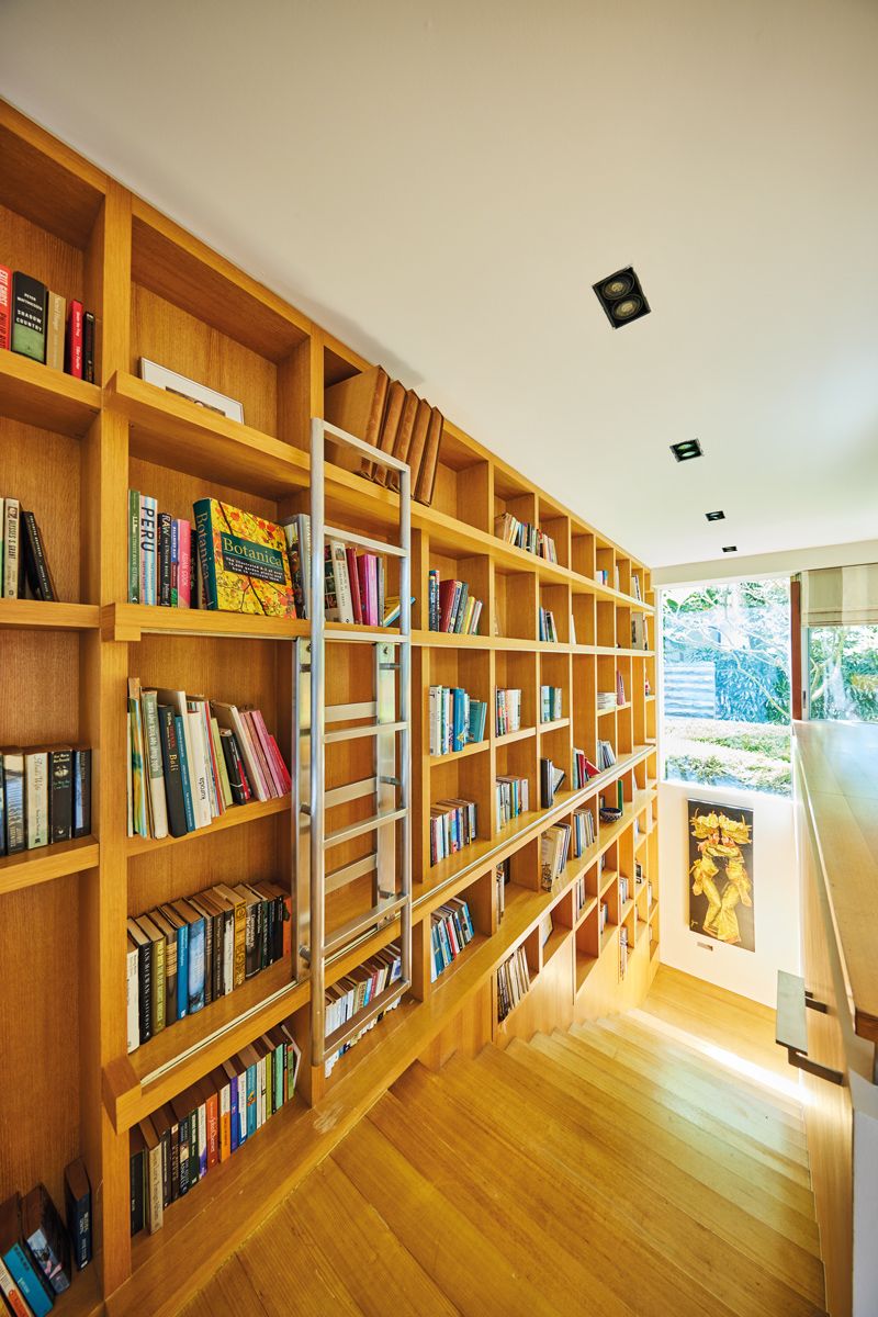 The Good Class Bungalow's original TV room library wall is a design highlight that houses the homeowner’s cherished book collection