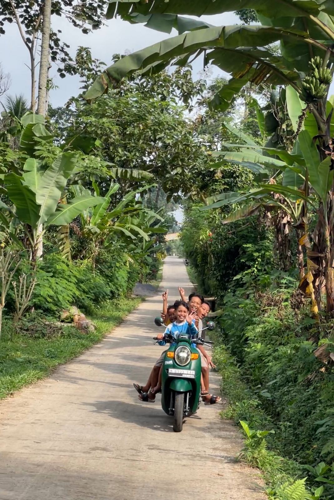 Indonesian children playing on the road leading to Tumpak Sewu Waterfalls