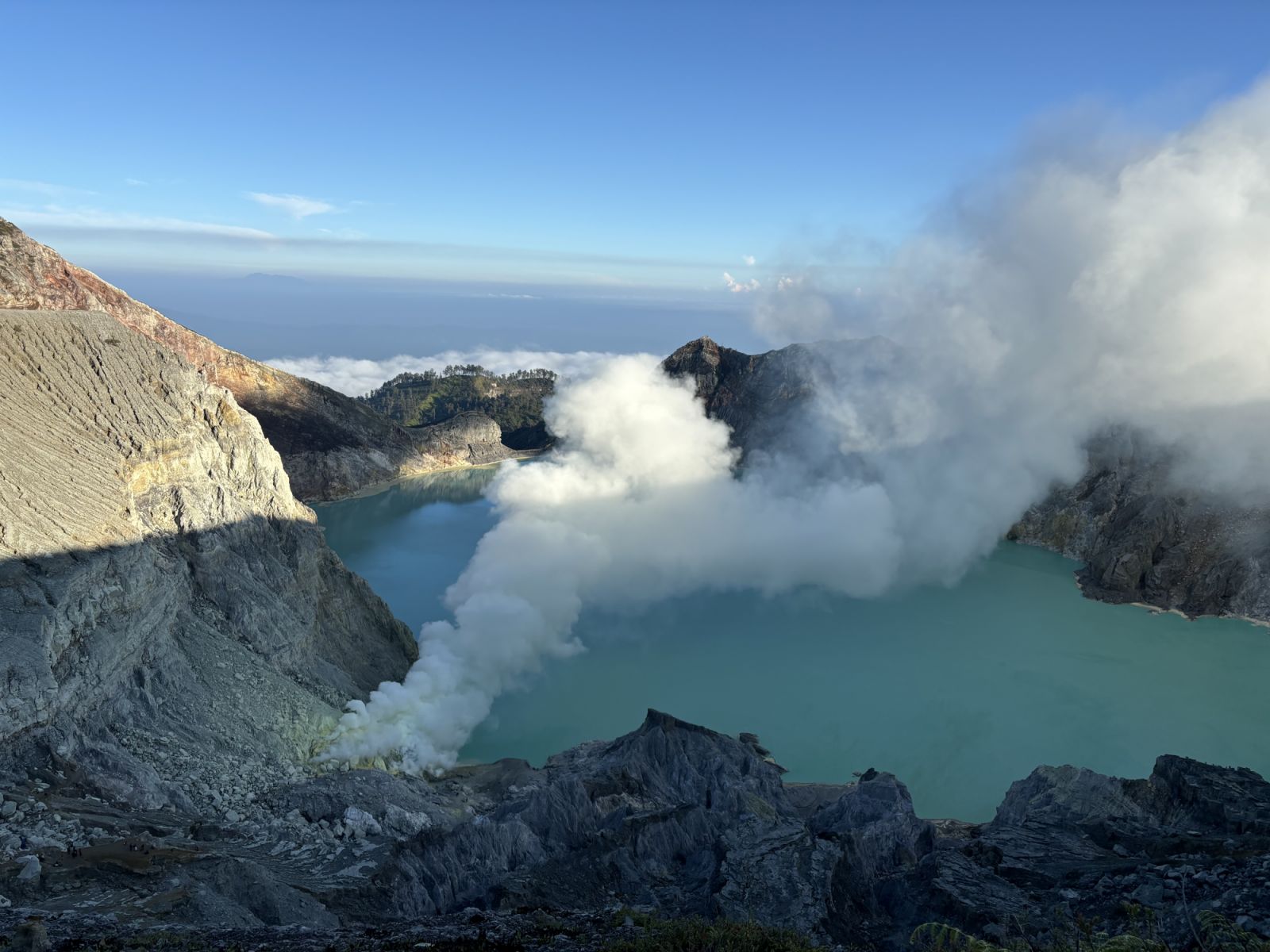 moke from a sulphur spring next to the Ijen crater lake, the most acidic lake in the world