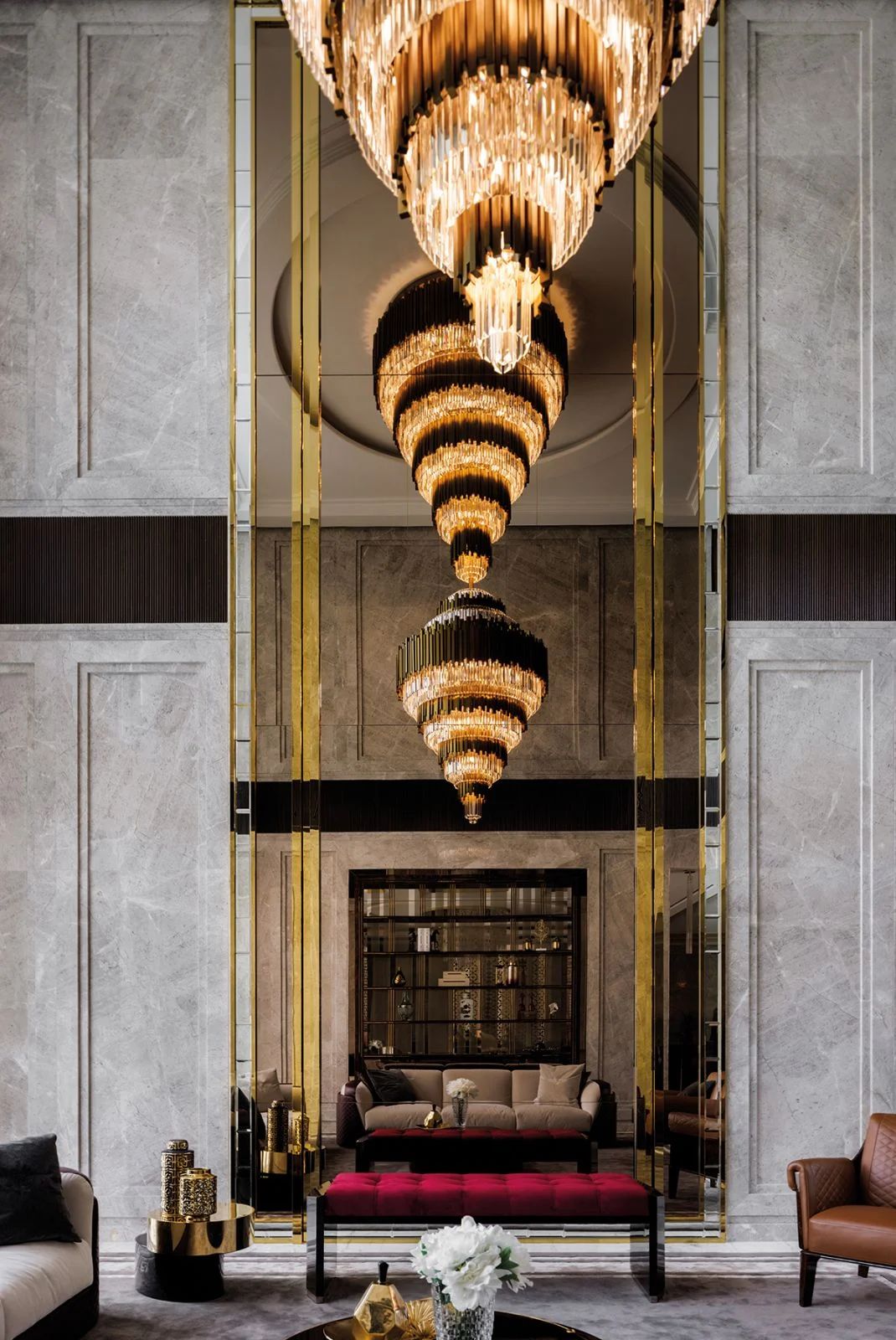A bespoke chandelier plated in gold in the living room with full-height mirrored wall panels (Photo: Marq HQO)