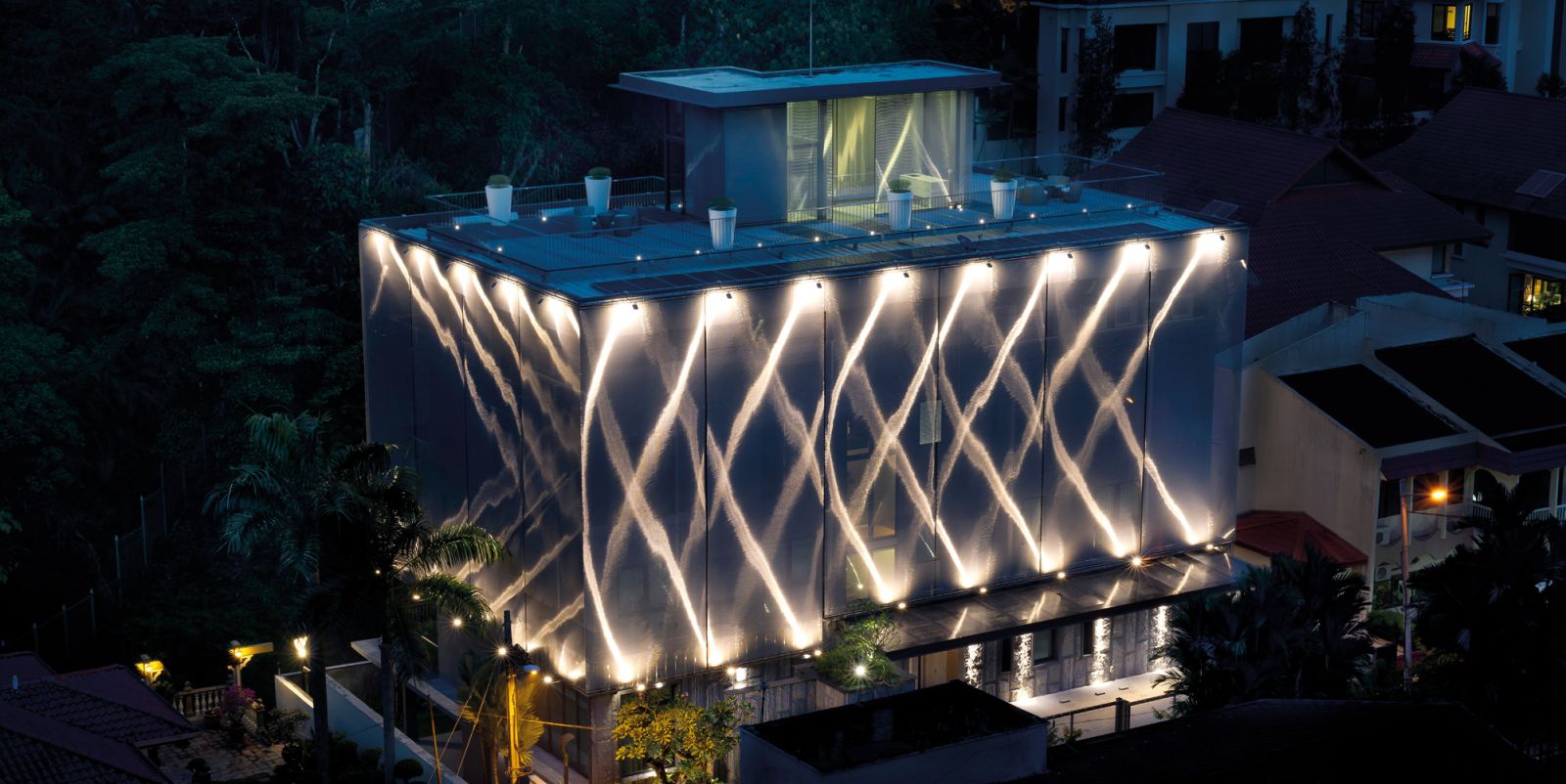 An exterior perspective of the Fabric House by DrTanLM Architect, as seen at night (Photo: DrTanLM Architect)