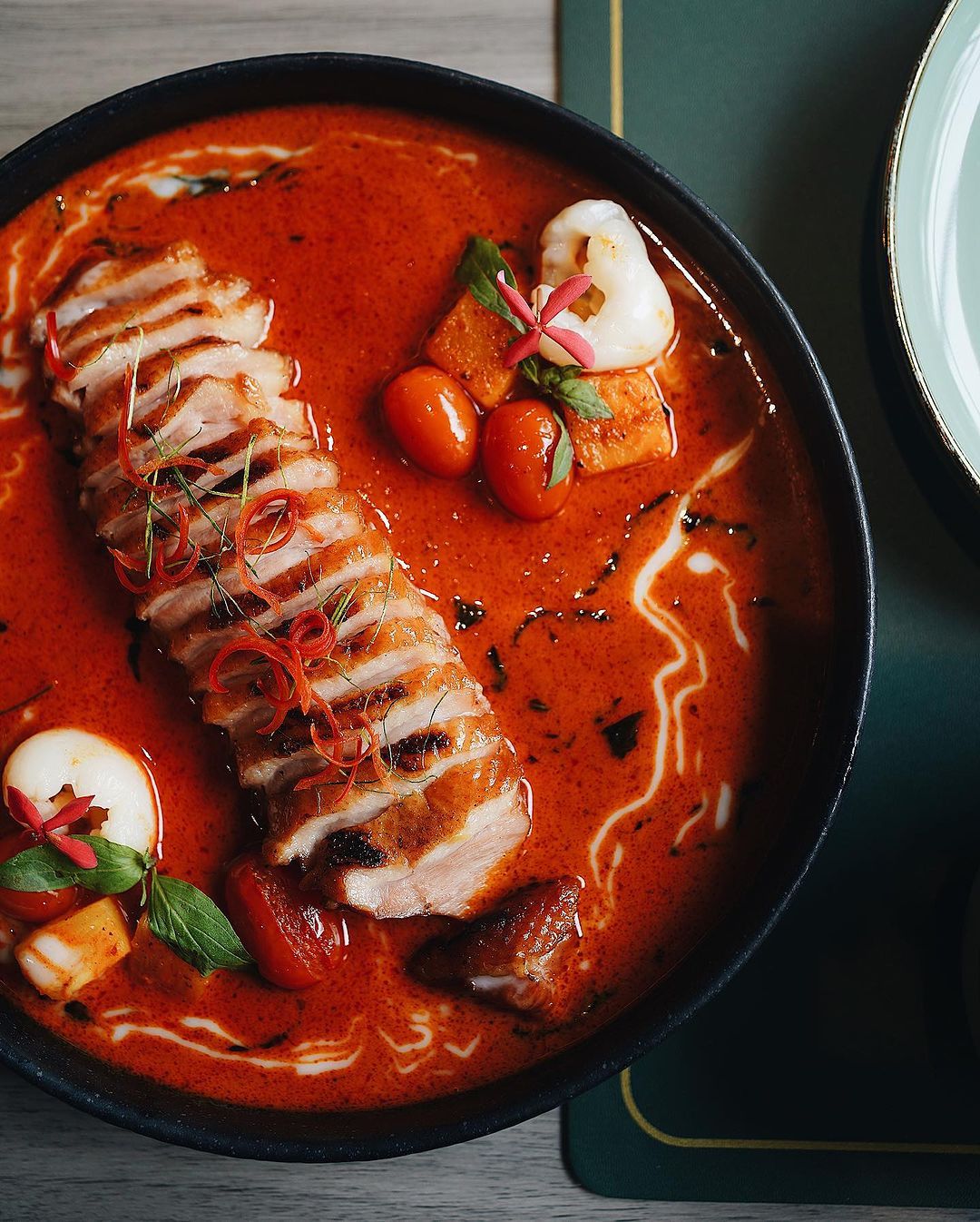 Smoked duck breast in red curry (Photo: Instagram / @napathai.cuisine)