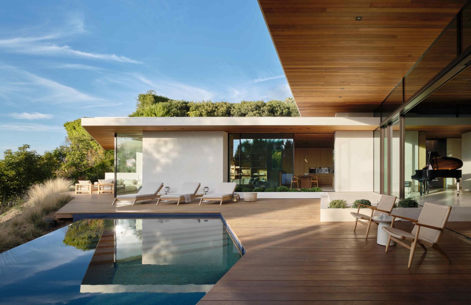The curved pool at the rear of the home