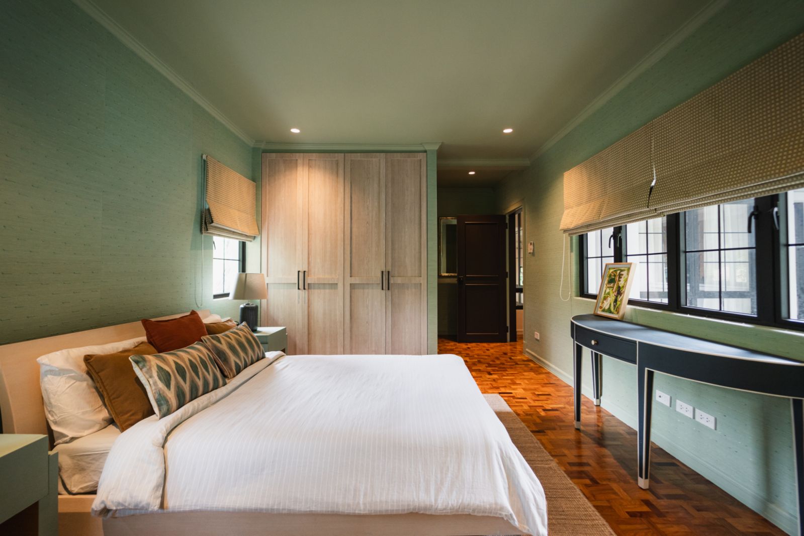 The bedroom, which features soothing abaca wallpaper