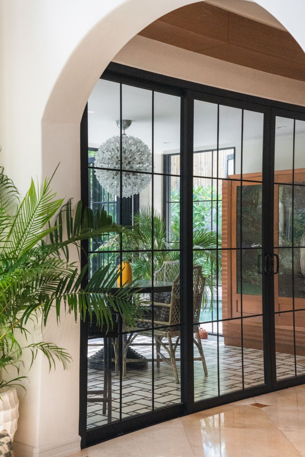 The lanai, featuring the vintage Murano glass flower chandelier by Paolo Venini