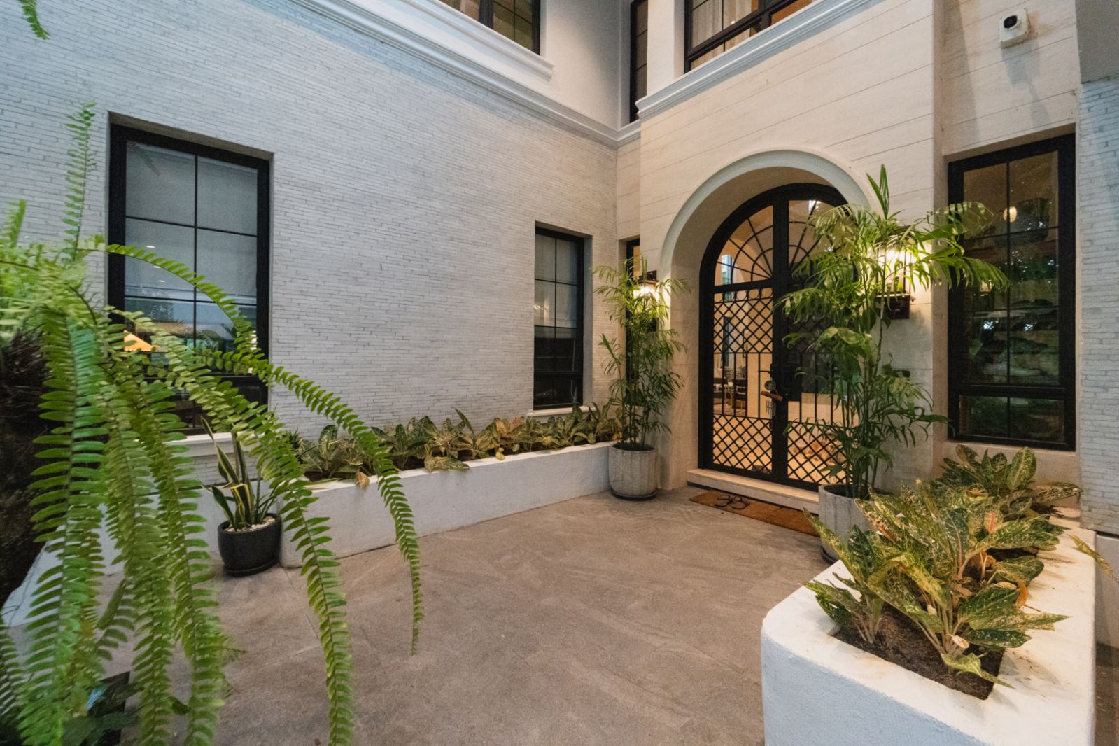 The outdoor area of the home, featuring lush greenery