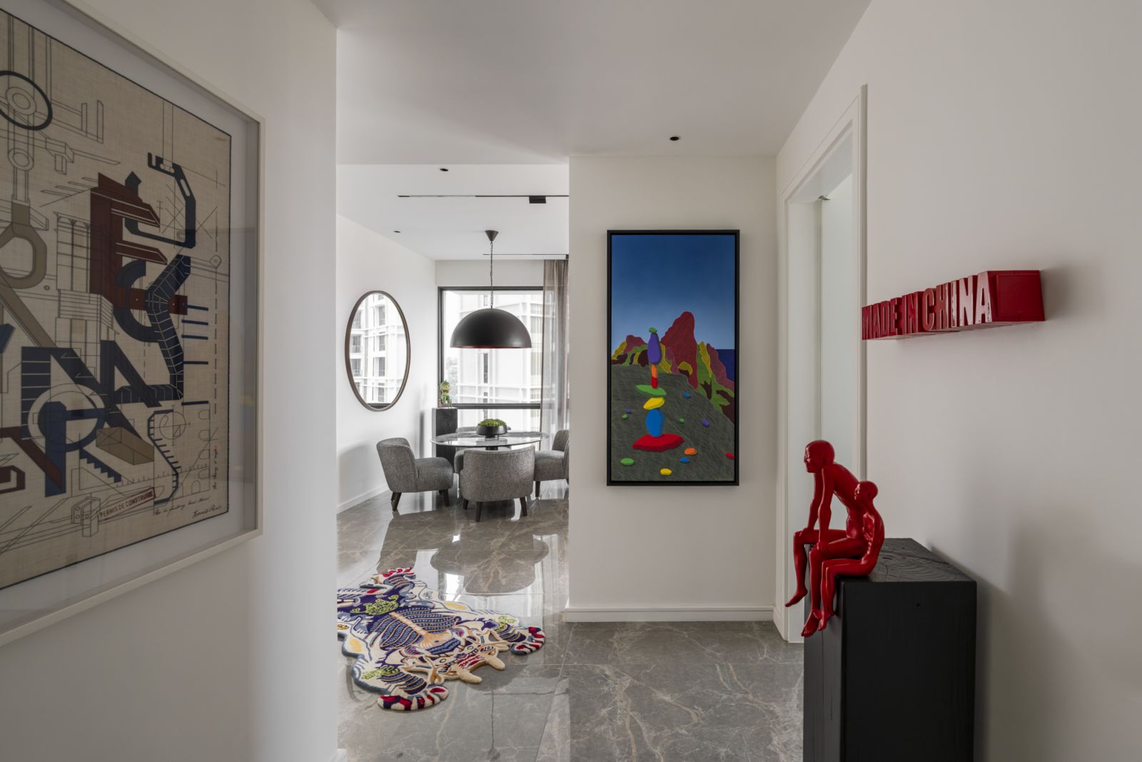 The hallway adorned with eclectic artwork, including sculptures by Chen Wen Ling and Shui Jian Guo and a painting by Syed Fakaruddin