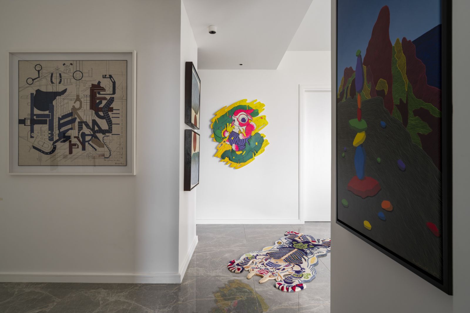 This hallway celebrates bold colors and playful forms, with a mixed medium piece by Syafiq Harizul and a tiger-shaped rug