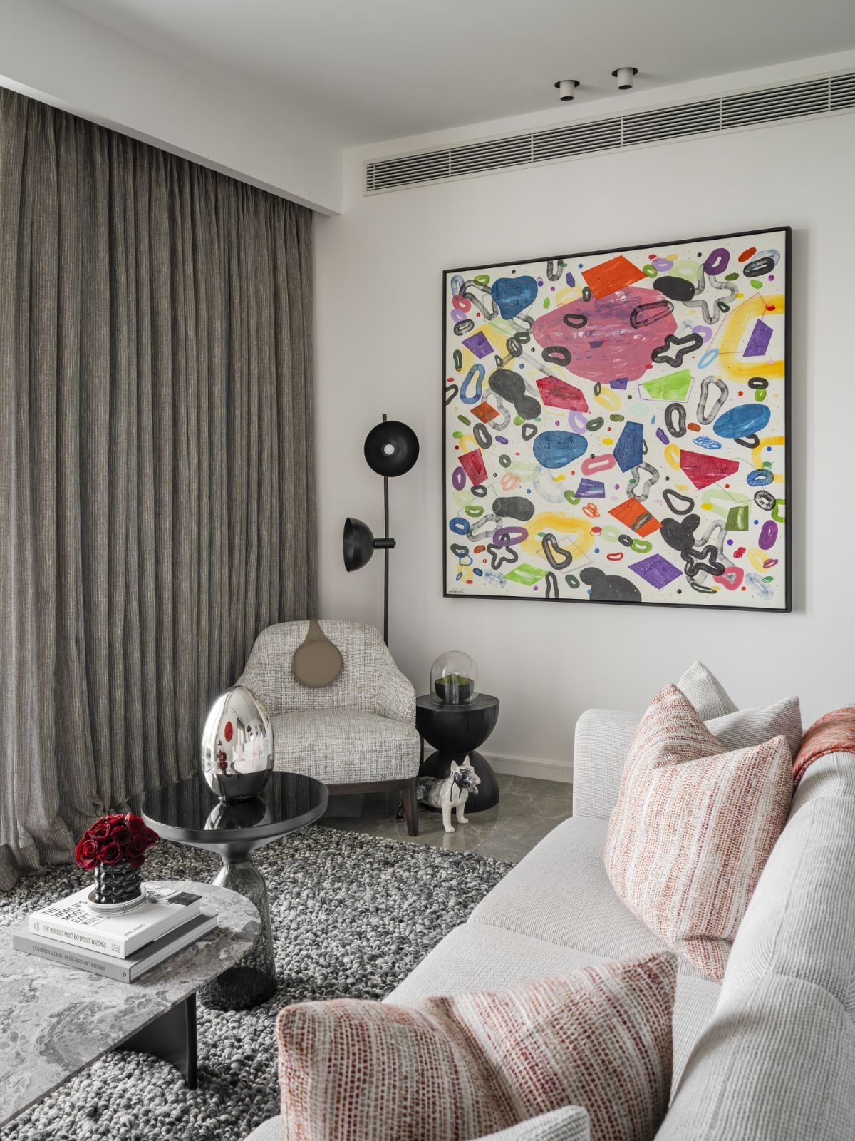 The living room showcases Liew and Hong's art collection, featuring a vibrant contemporary piece above a designer armchair