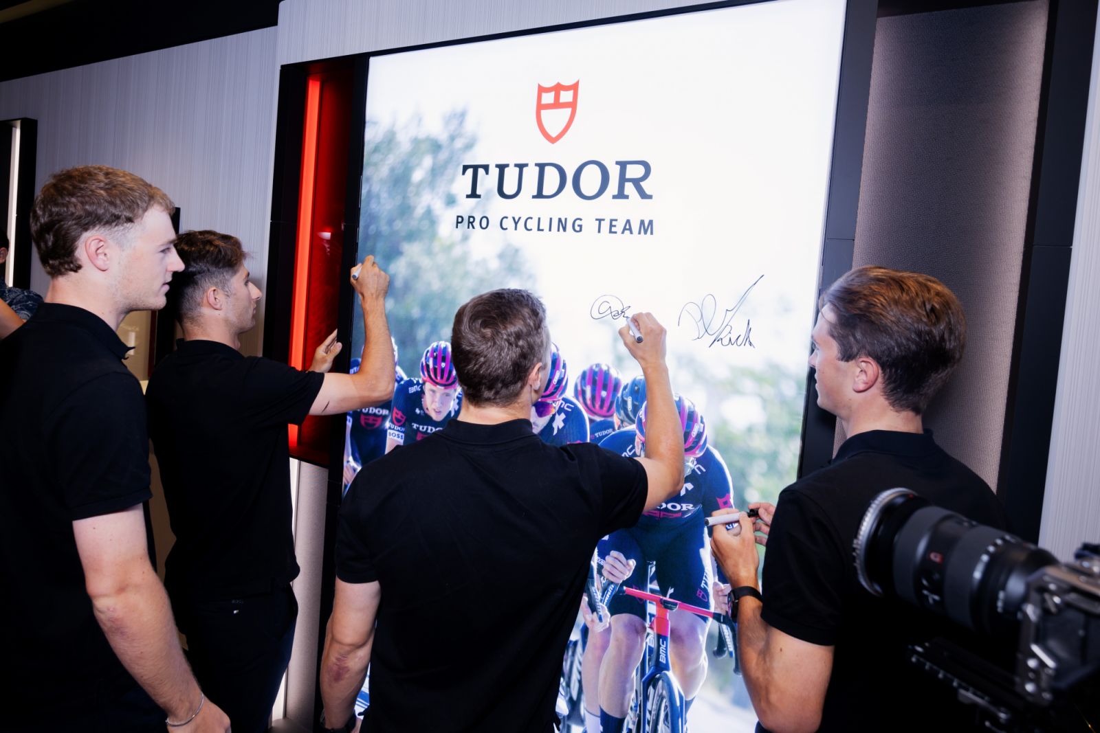 The Tudor Pro Cycling Team signing its display in the Tudor boutique
