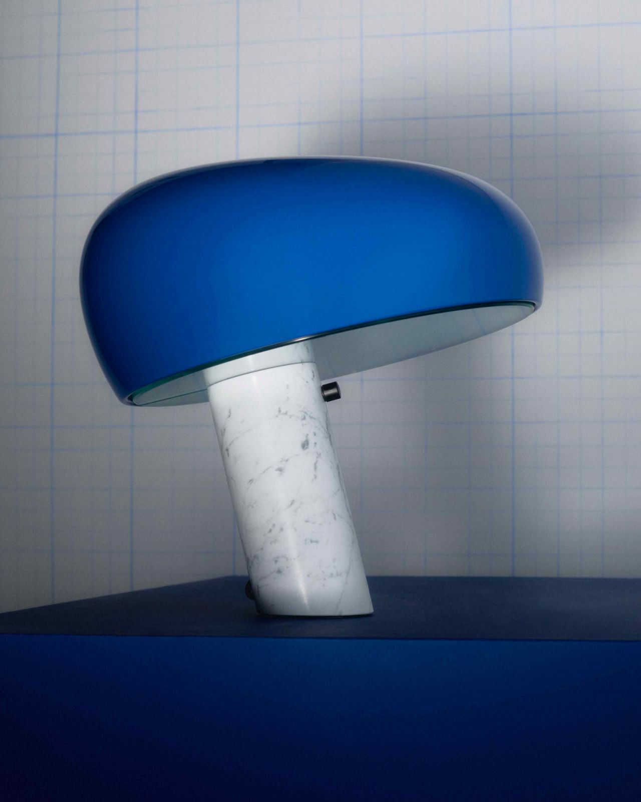 The Carrara marble base is set at an oblique angle