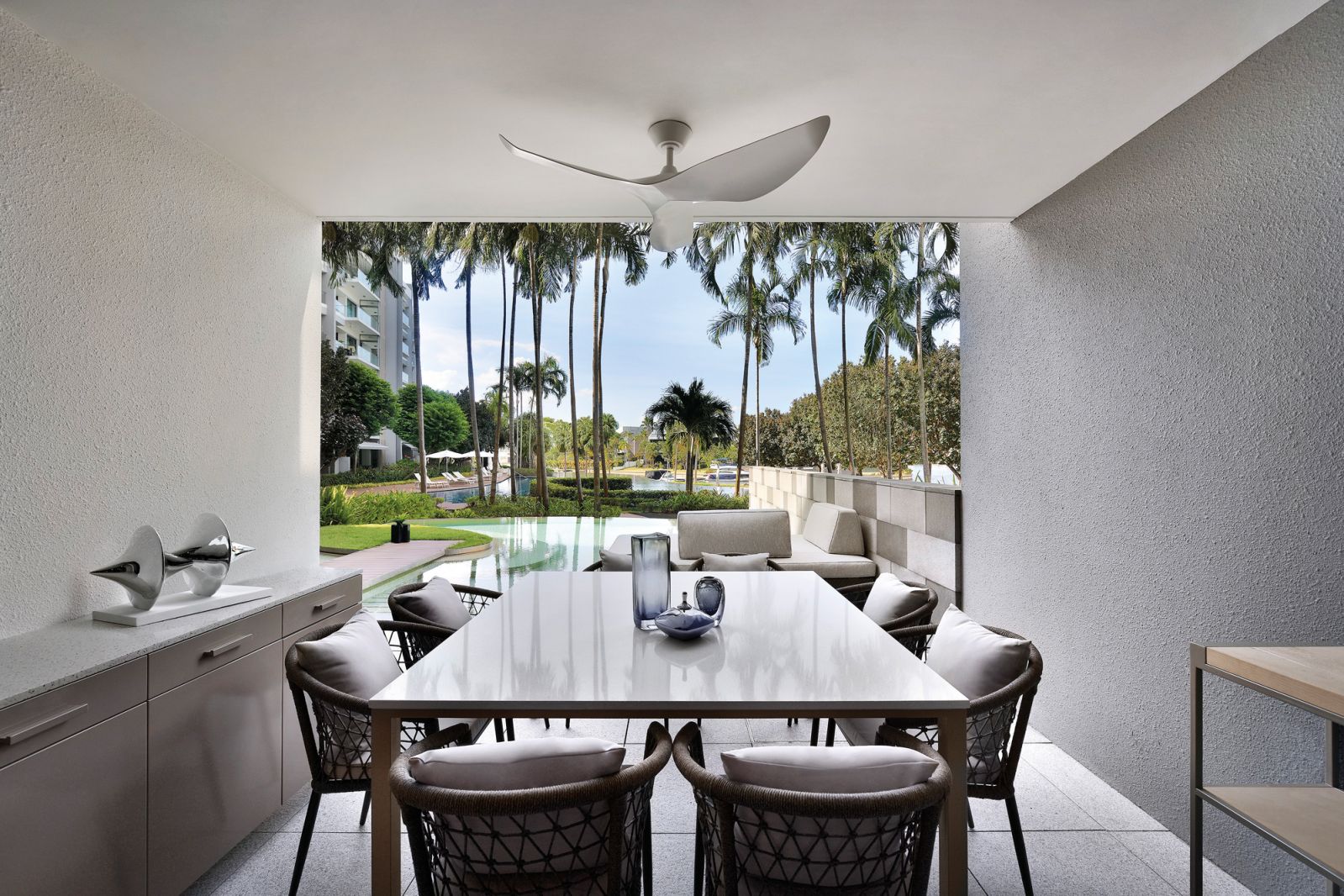 One of the perks of a ground-level unit: an al fresco dining zone with a view of and direct access to the pool
