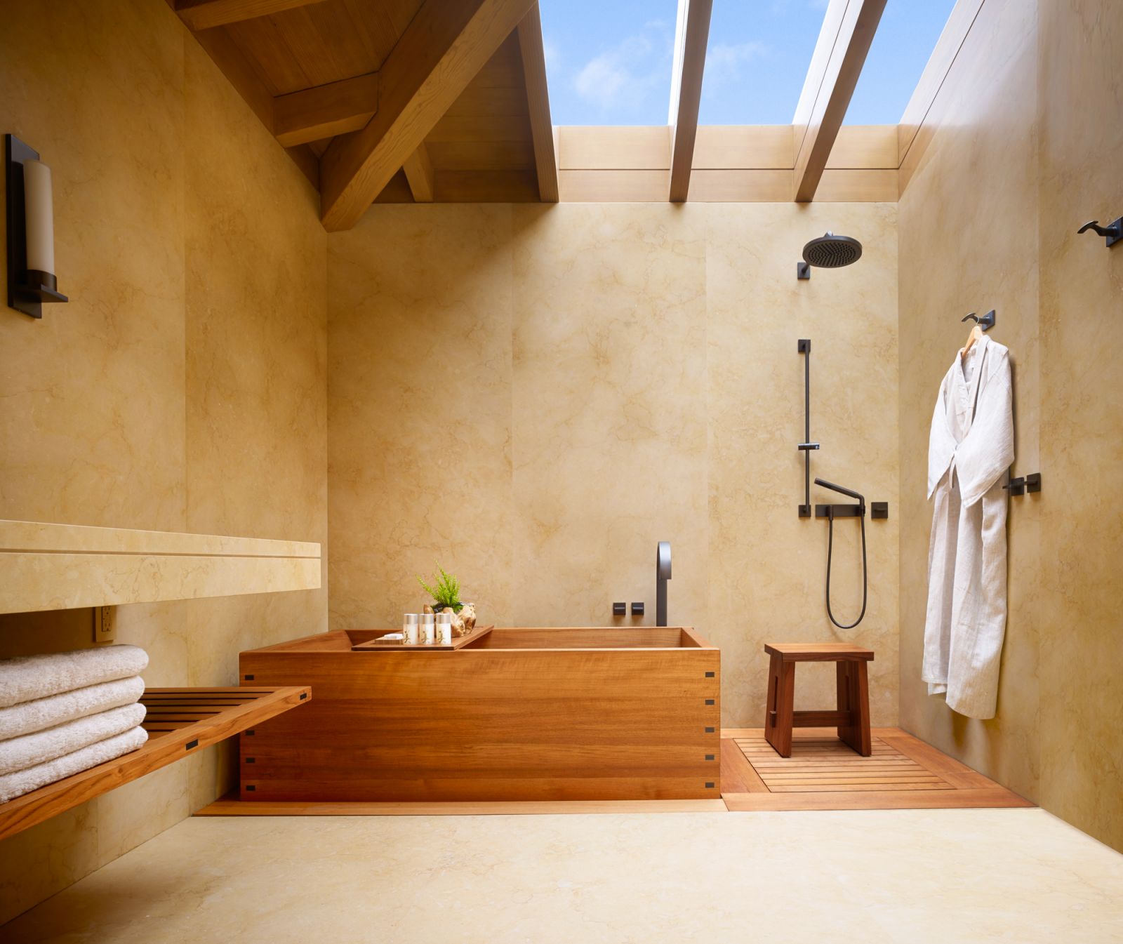 Handcrafted teak soaking tubs positioned beneath skylights (Photo: Nobu Ryokan Malibu)