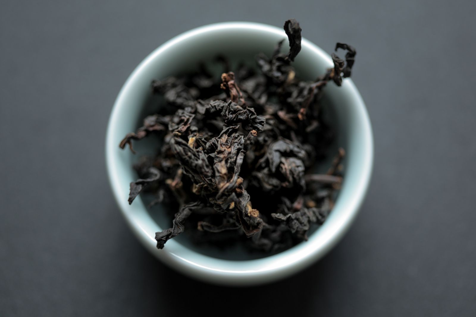 Organically-grown Taiwanese black tea of the Daye Oolong cultivar in a celadon teacup.
