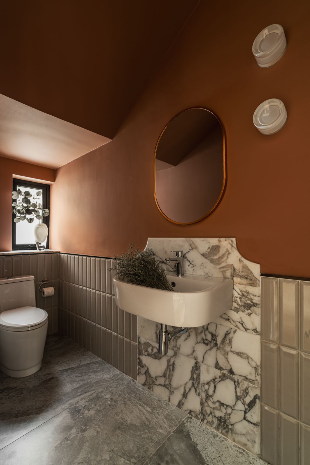 The bathroom has a deft mix of materials