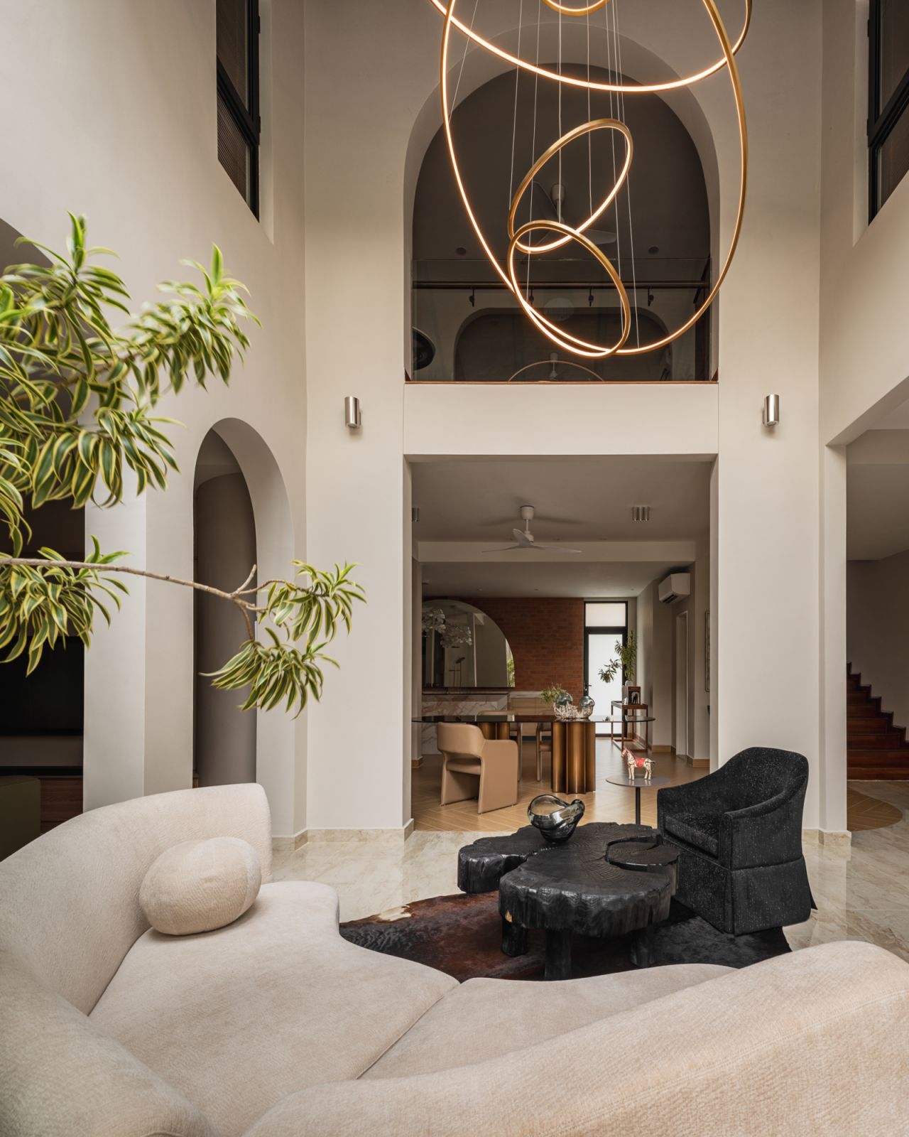 A modern sculputural chandelier adds a sense of occasion to the living room