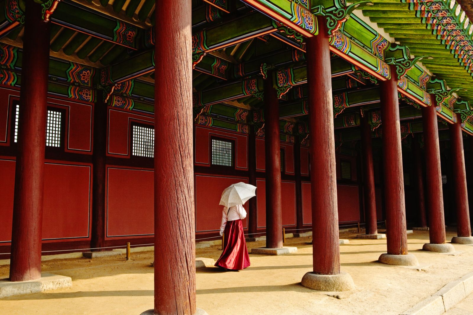 Female Palace official walking with umbrella in Gyeongbokgung Palace