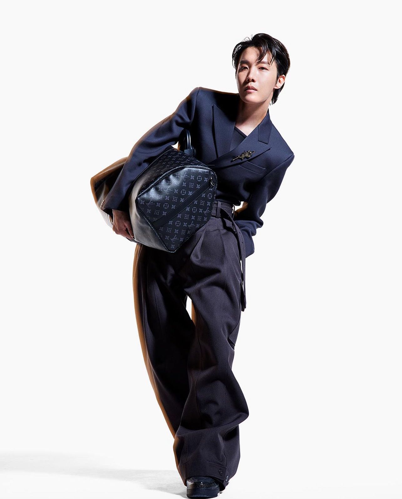 j-hope holding the Keepall bag for his solo Louis Vuitton campaign (Photo: Instagram / Louis Vuitton)