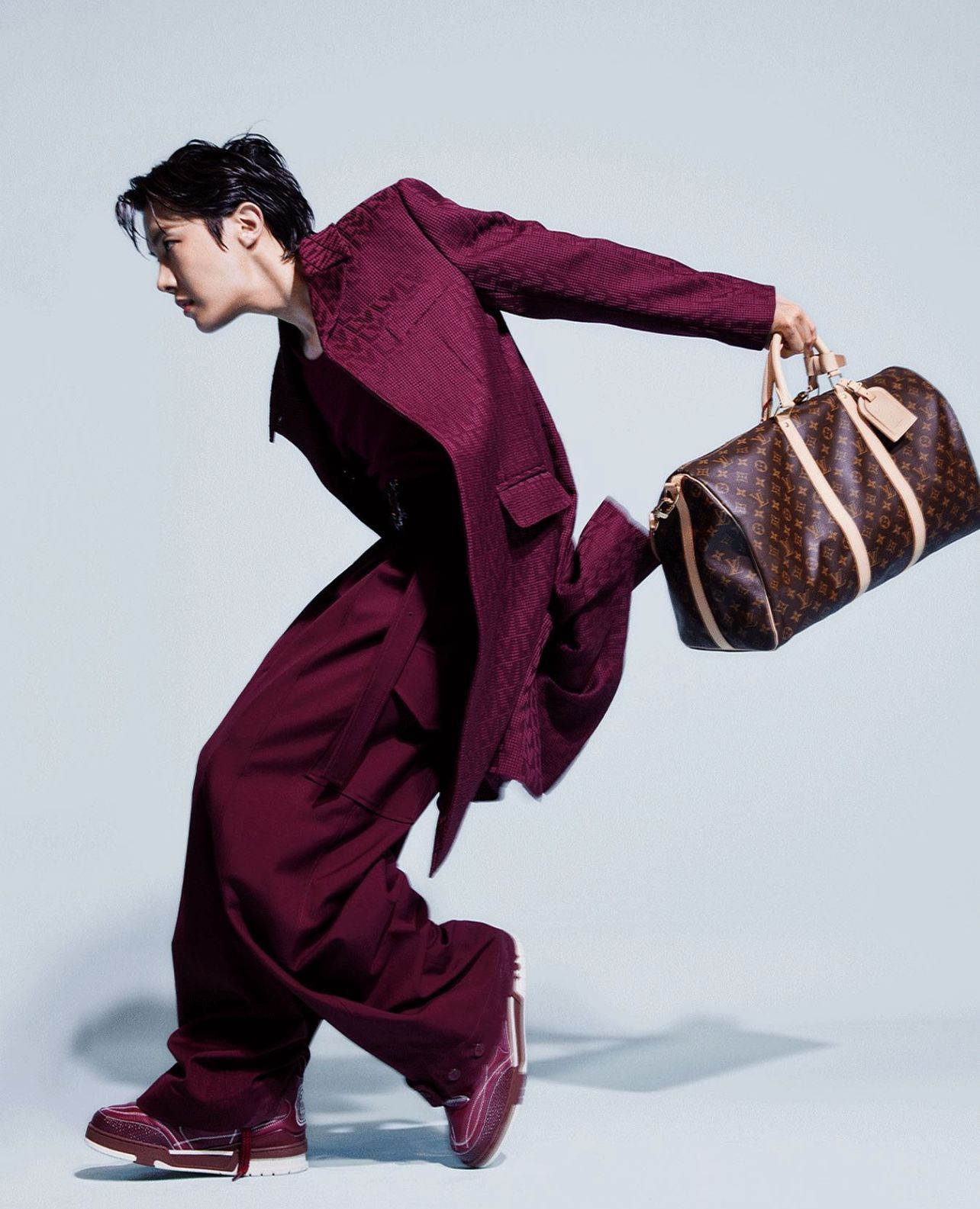 j-hope holding the Keepall bag for his solo Louis Vuitton campaign (Photo: Instagram / Louis Vuitton)