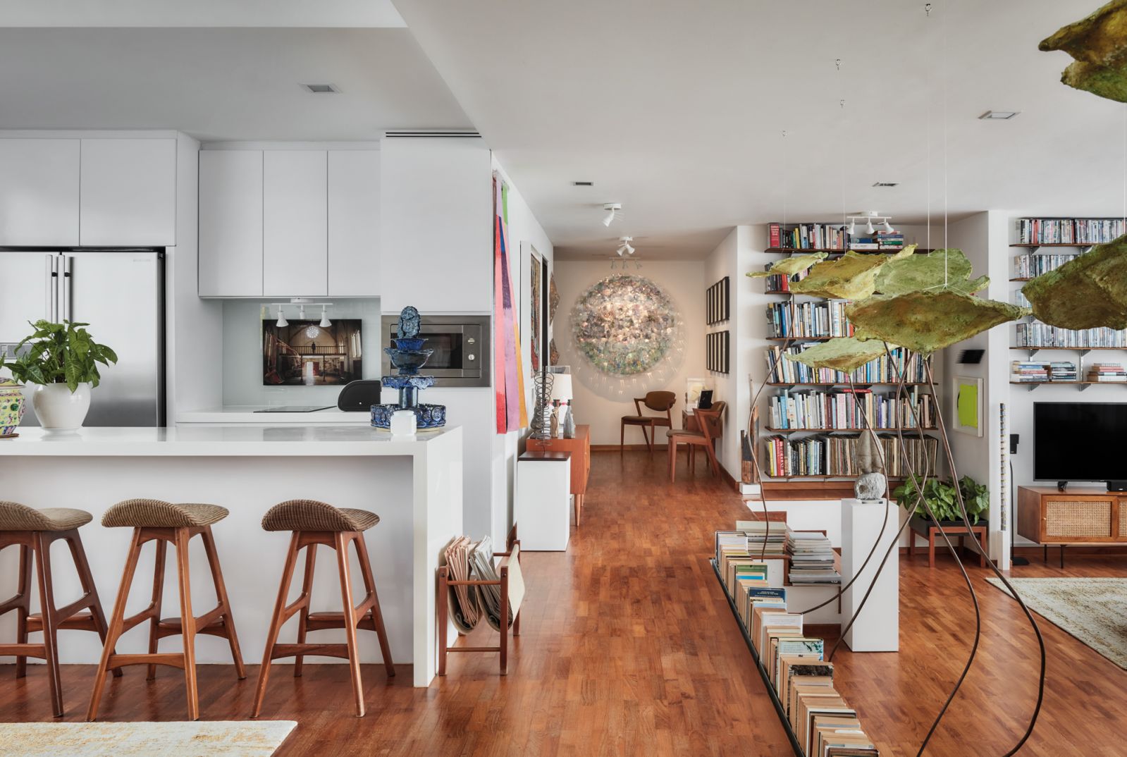 A view of the hallway, with the kitchen and dining area to the left and the living room to the right