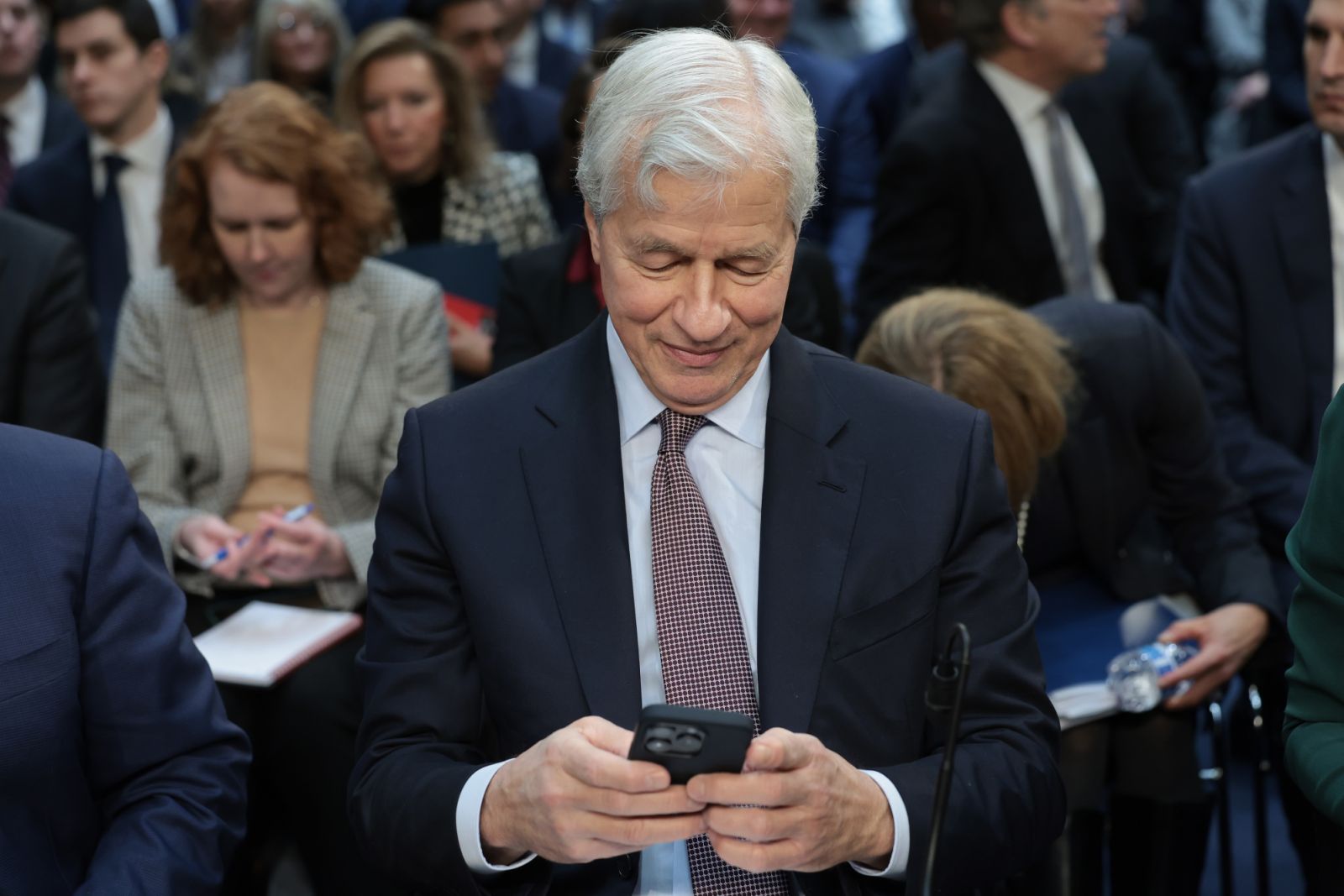 WASHINGTON, DC - DECEMBER 06: Jamie Dimon, Chairman and CEO of JPMorgan Chase, uses a phone as he arrives to testify at a Senate Banking Committee hearing at the Hart Senate Office Building on December 06, 2023 in Washington, DC. The committee heard testimony from the largest financial institutions during an oversight hearing on Wall Street firms. (Photo by Win McNamee/Getty Images)