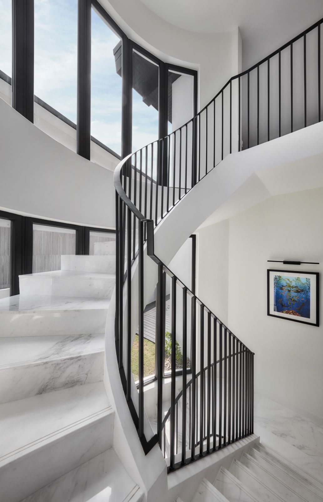 The new black railing makes the spiral staircase pop all the way up to the private quarters