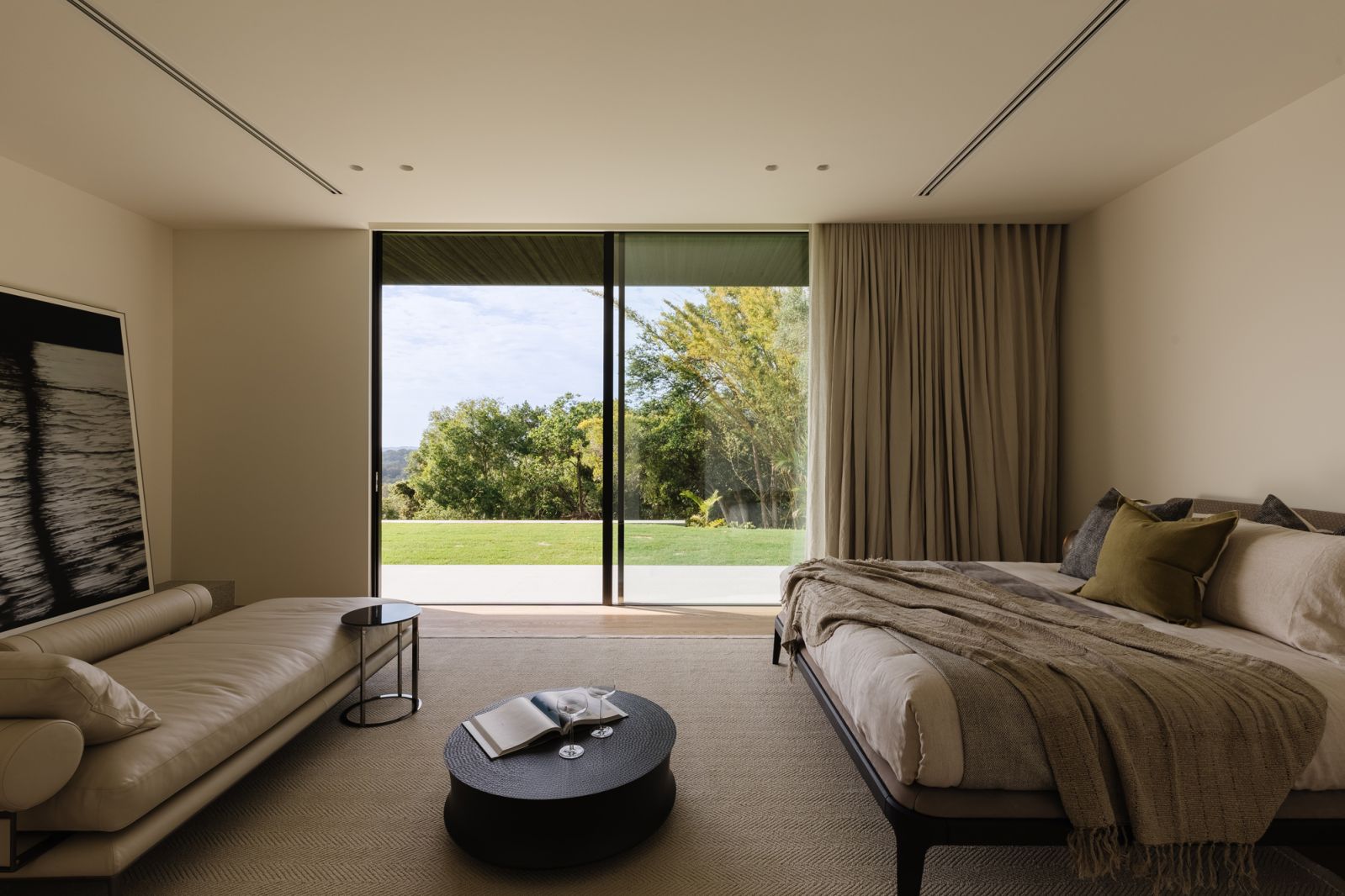 This bedroom in the Noosa house boasts unblocked views of the verdant exteriors